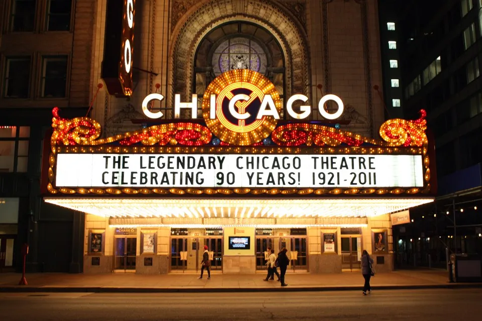 The illuminated Chicago Theatre marquee and vertical sign at night.