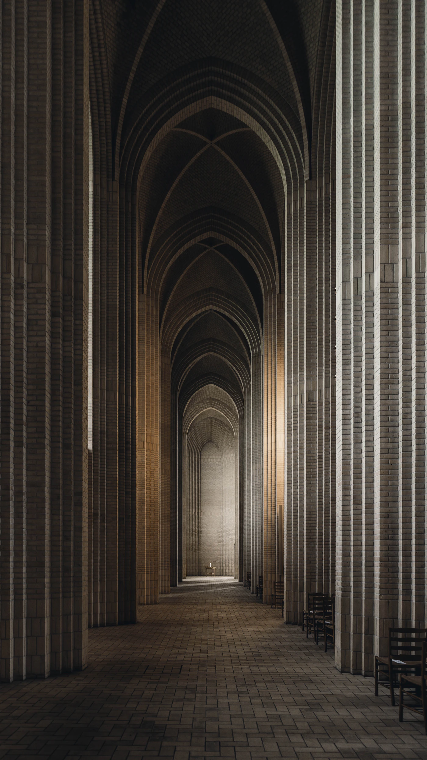 Sunlight and shadow along a stone colonnade
