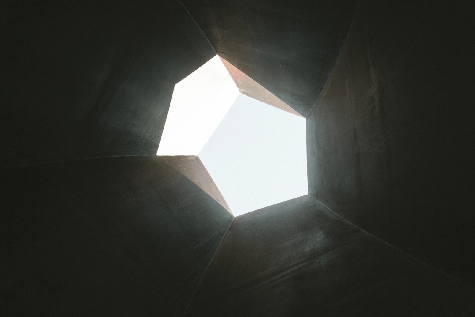A geometric skylight opening toward a clear sky